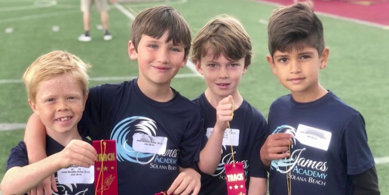 Students with track medals at St. James Academy